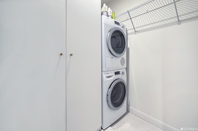 clothes washing area with stacked washer and clothes dryer