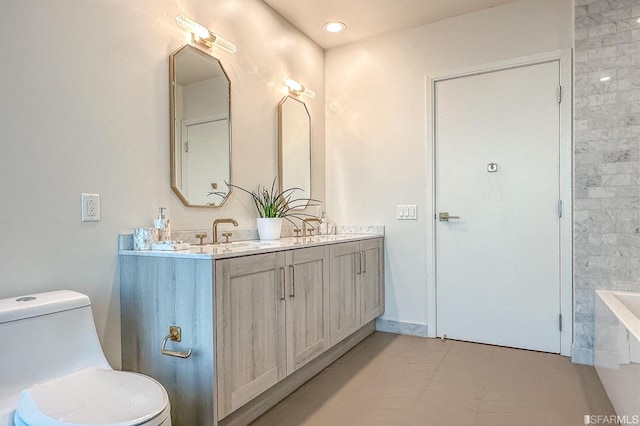 bathroom featuring vanity, toilet, tile patterned floors, and a bathing tub