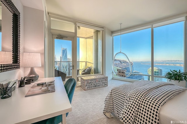 bedroom featuring carpet, multiple windows, and a water view