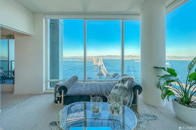 living room with carpet and a water view