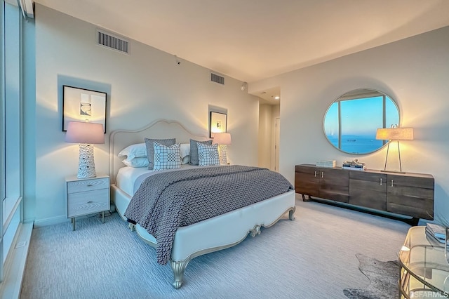 bedroom featuring light colored carpet