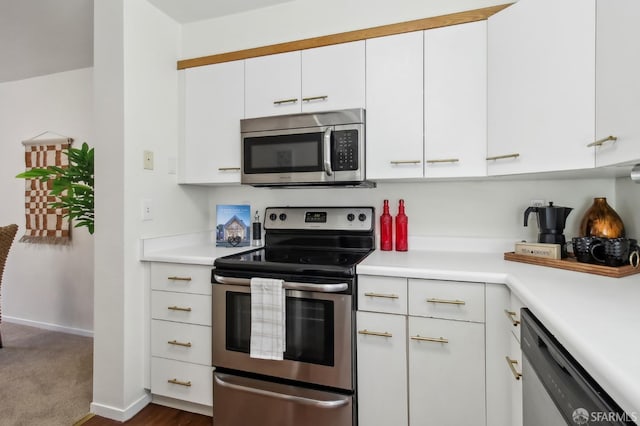 1945 Washington St Unit 412, San Francisco, CA 94109 - kitchen with appliances with stainless steel finishes, light countertops, white cabinets, and baseboards