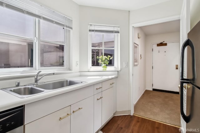 1945 Washington St Unit 412, San Francisco, CA 94109 - kitchen with freestanding refrigerator, a sink, dishwashing machine, white cabinets, and light countertops