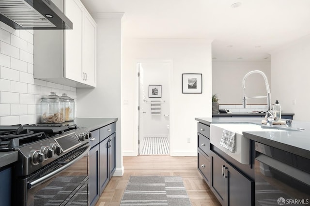 1643 43rd Ave, San Francisco, CA 94122 - kitchen featuring range hood, stainless steel range with gas stovetop, dishwasher, backsplash, and white cabinets