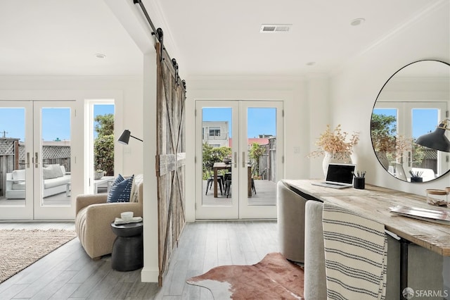 1643 43rd Ave, San Francisco, CA 94122 - doorway with french doors, crown molding, light wood-type flooring, and a barn door