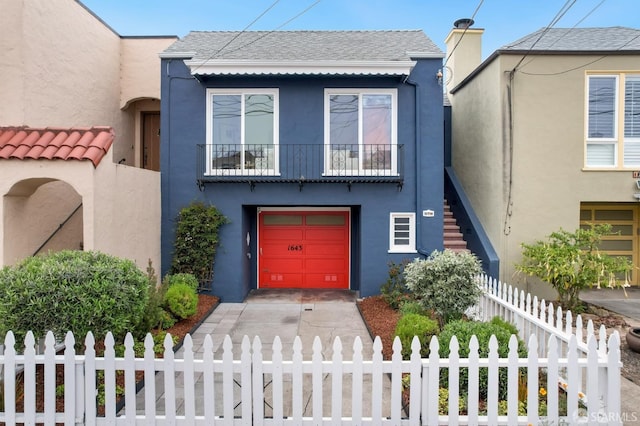 1643 43rd Ave, San Francisco, CA 94122 - view of front of property featuring stucco siding, a fenced front yard, and a garage