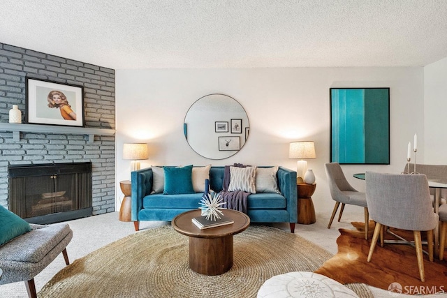 living room featuring a textured ceiling and a fireplace