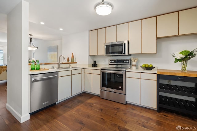 601 Van Ness Ave Unit 35, San Francisco, CA 94102 - kitchen featuring appliances with stainless steel finishes, beverage cooler, light countertops, cream cabinets, and recessed lighting