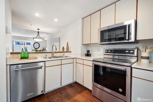 601 Van Ness Ave Unit 35, San Francisco, CA 94102 - kitchen featuring stainless steel appliances, light countertops, dark wood-style flooring, decorative light fixtures, and recessed lighting