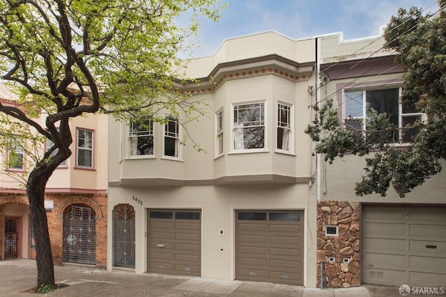 view of front of property with stucco siding and an attached garage