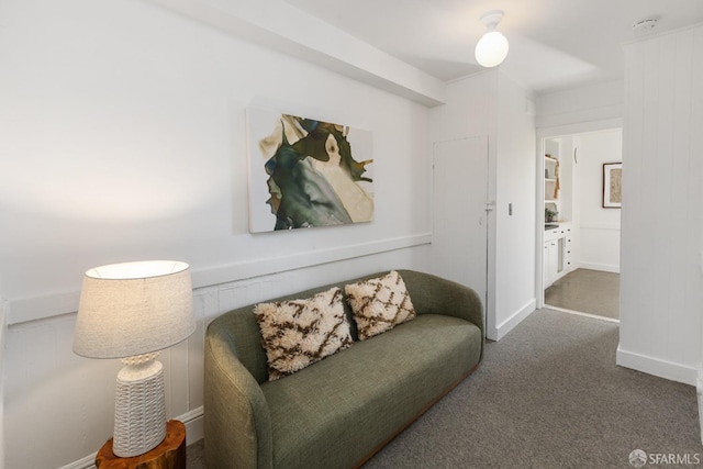 living area featuring carpet and baseboards