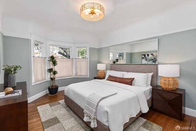 bedroom featuring baseboards and wood finished floors