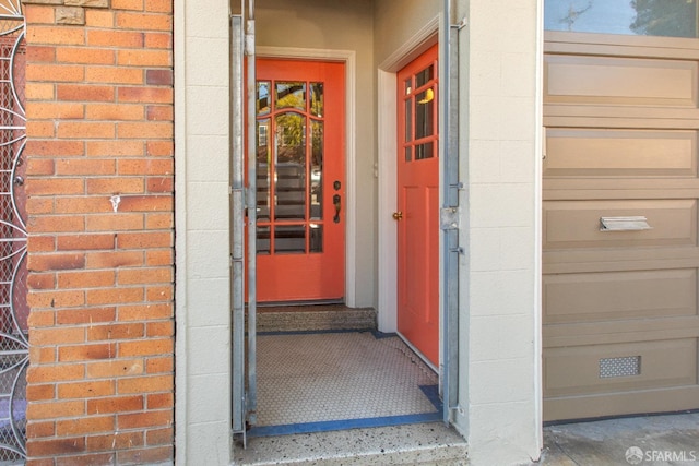 view of exterior entry with brick siding