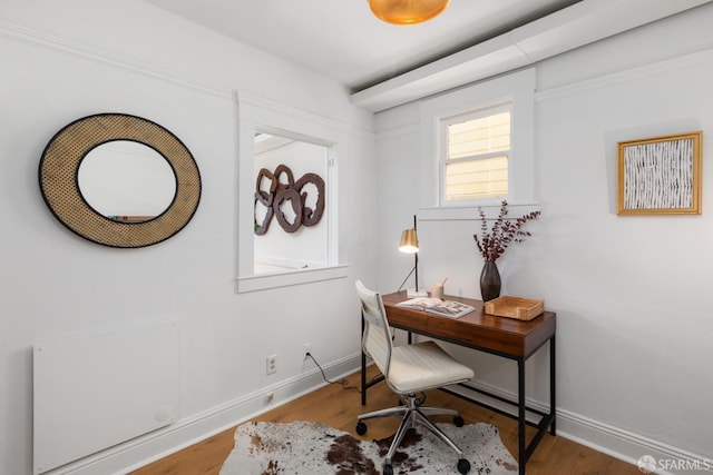 office space featuring baseboards and wood finished floors