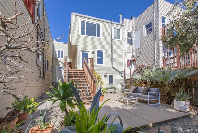 rear view of house with stairway, an outdoor hangout area, and a patio area