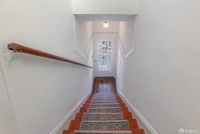 staircase featuring baseboards