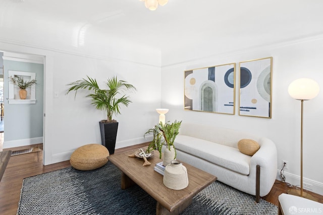 living area featuring baseboards and wood finished floors