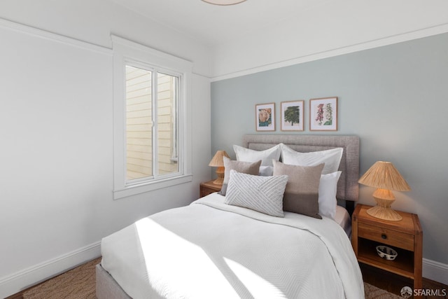 bedroom with multiple windows and baseboards