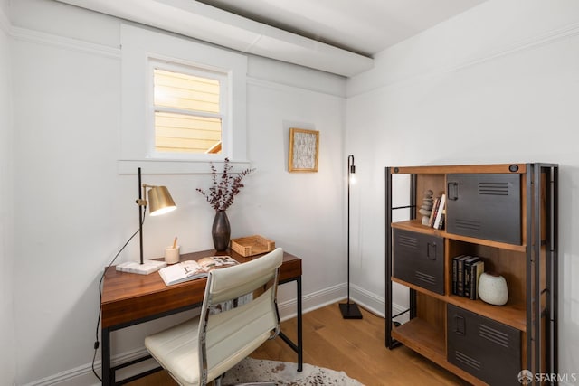 office space with baseboards and wood finished floors