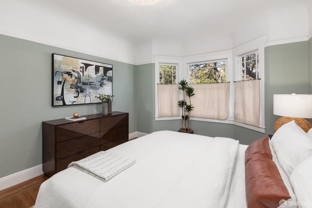 bedroom featuring baseboards and wood finished floors