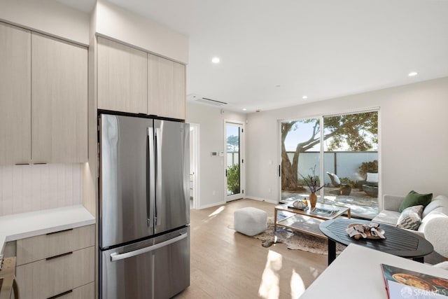 kitchen with freestanding refrigerator, modern cabinets, light wood-type flooring, open floor plan, and recessed lighting