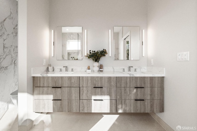 full bathroom featuring double vanity and toilet