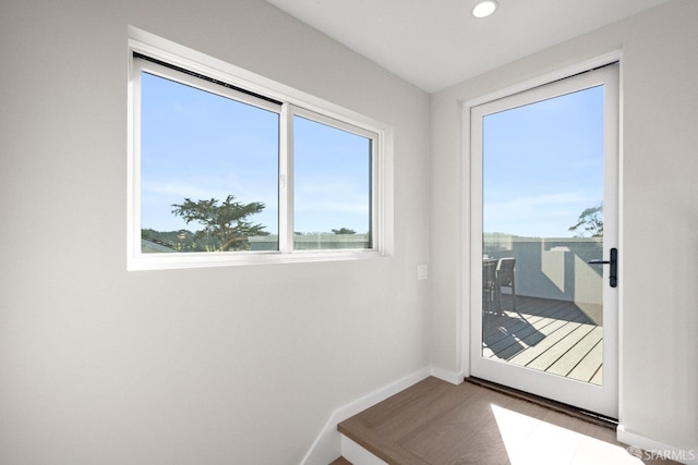 doorway to outside with baseboards and recessed lighting