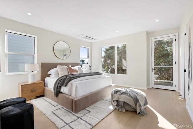 bedroom featuring access to exterior, light wood finished floors, and recessed lighting
