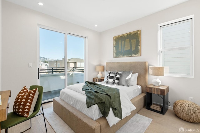 bedroom with access to outside, wood finished floors, recessed lighting, and baseboards