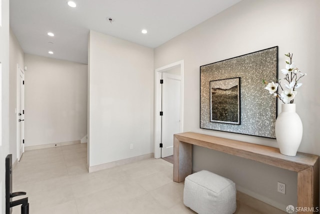 corridor featuring recessed lighting, baseboards, and tile patterned flooring