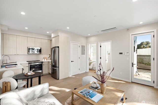 living area featuring light wood-style floors and recessed lighting