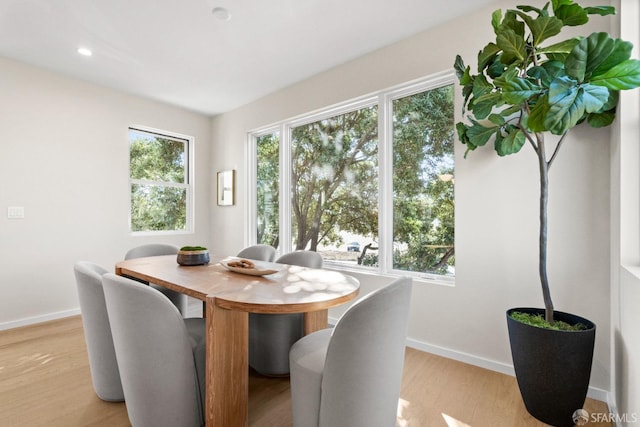 dining area with baseboards, light wood-style floors, and recessed lighting