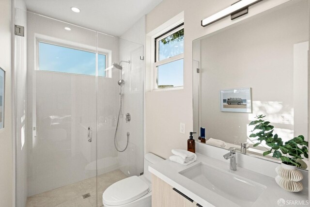 bathroom with a stall shower, toilet, vanity, recessed lighting, and tile patterned floors