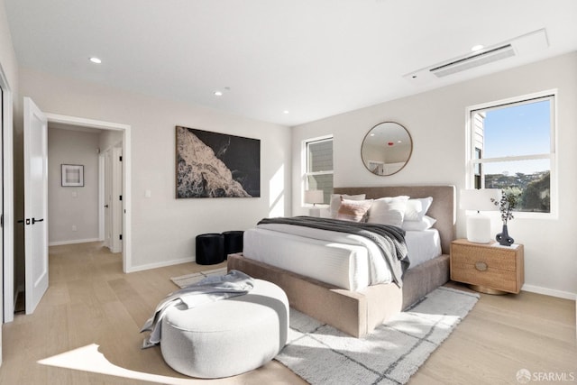 bedroom with light wood-type flooring, baseboards, and recessed lighting