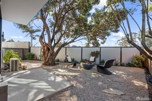view of patio with a fire pit and a fenced backyard
