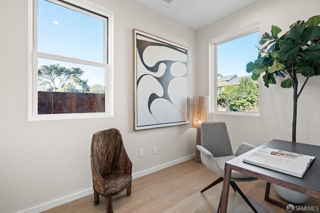 home office featuring light wood-type flooring and baseboards