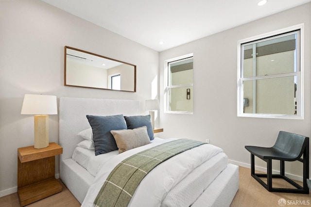 bedroom with recessed lighting, baseboards, and wood finished floors