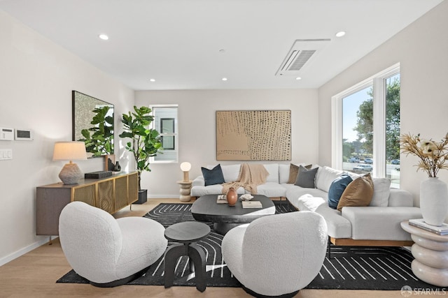 living room featuring recessed lighting, light wood finished floors, and baseboards