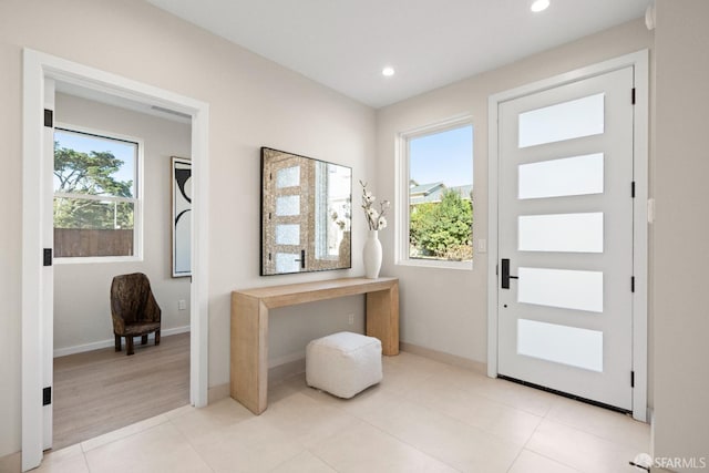 doorway to outside with healthy amount of natural light, recessed lighting, and baseboards