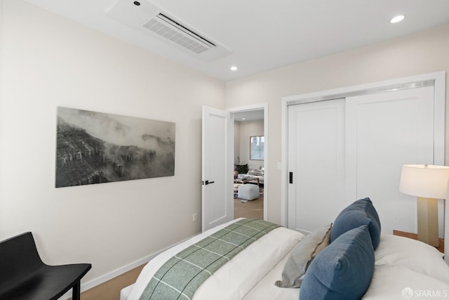 bedroom with recessed lighting, a closet, and baseboards