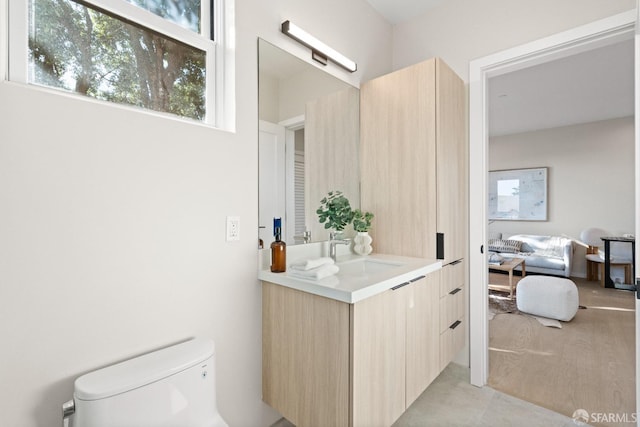 bathroom featuring toilet and vanity