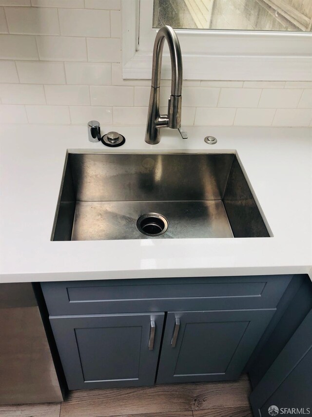 3870 18th St, San Francisco, CA 94114 - kitchen view of a sink, light countertops, gray cabinets, and wood finished floors
