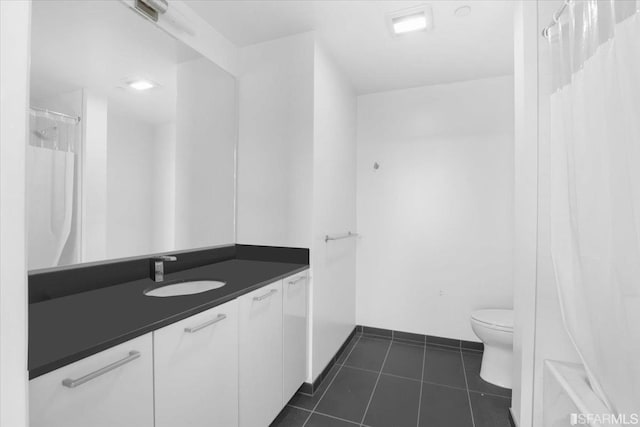 bathroom featuring tile patterned flooring, vanity, and toilet