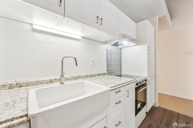 95 Ora Way Unit 303F, San Francisco, CA 94131 - kitchen featuring high end stove, dark wood-style flooring, premium range hood, and white cabinetry