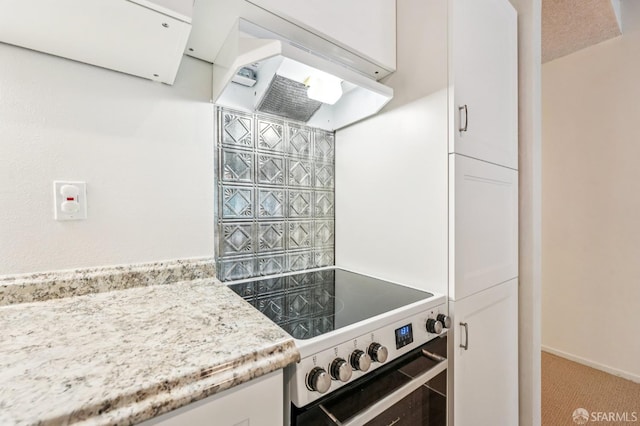 95 Ora Way Unit 303F, San Francisco, CA 94131 - kitchen featuring electric stove, white cabinetry, premium range hood, and carpet