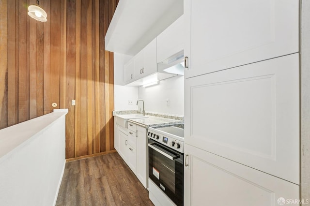 95 Ora Way Unit 303F, San Francisco, CA 94131 - kitchen with range, wood walls, dark wood-style flooring, white cabinets, and extractor fan