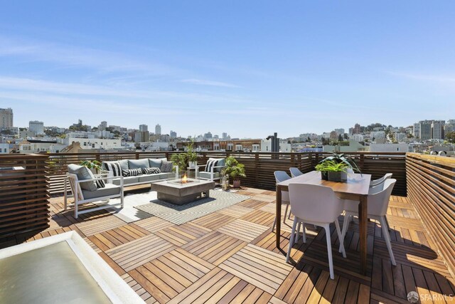 3226 Octavia St, San Francisco, CA 94123 - wooden deck with an outdoor living space with a fire pit, a skyline view, and outdoor dining space