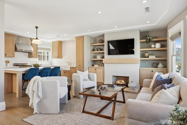 3226 Octavia St, San Francisco, CA 94123 - living area featuring light wood-style floors, recessed lighting, and a fireplace