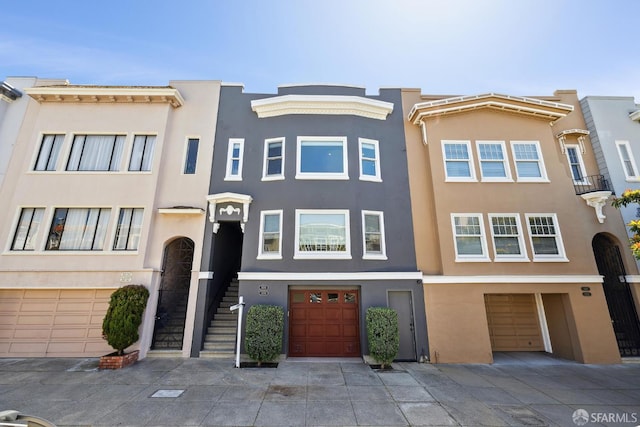 3226 Octavia St, San Francisco, CA 94123 - townhome / multi-family property with an attached garage, stucco siding, and concrete driveway