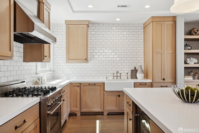 3226 Octavia St, San Francisco, CA 94123 - kitchen with wall chimney range hood, high end stove, a sink, light brown cabinets, and light countertops